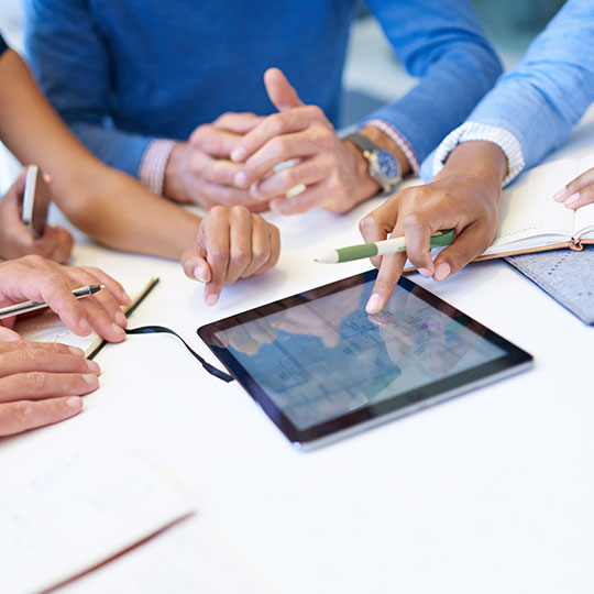 close up of people around a tablet