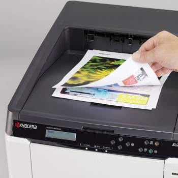 Páginas a color siendo recogidas de una impresora Kyocera
