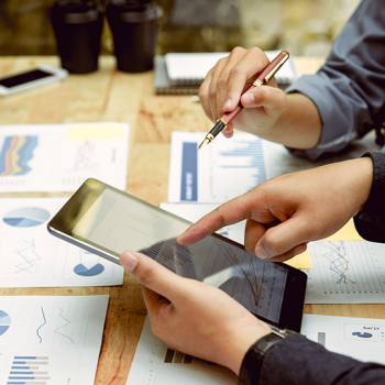 close up of people working on a tablet